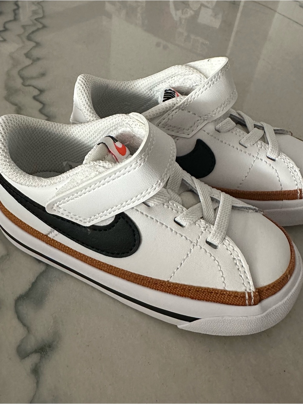 Nike Kids White Sneakers with Black Swoosh and Brown Accent